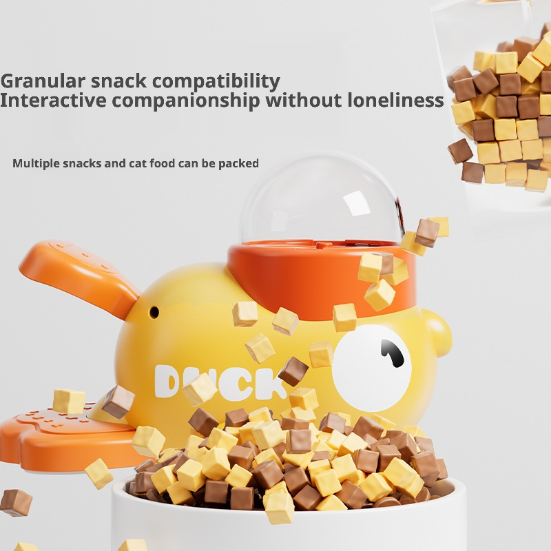 A playful yellow duck-shaped pet treat dispenser designed to hold pellet-type treats or cat food. When activated, it releases snacks randomly, encouraging interactive play and mental stimulation for cats and dogs. The transparent dome allows visibility of remaining treats, while the ergonomic design ensures safe, slow feeding to prevent choking or overeating. Ideal for keeping pets engaged and reducing loneliness during alone time.
